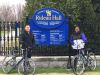 Tour guide is taking a picture of a couple in front of Rideau Hall during Ottawa express guided bike tour with Escape