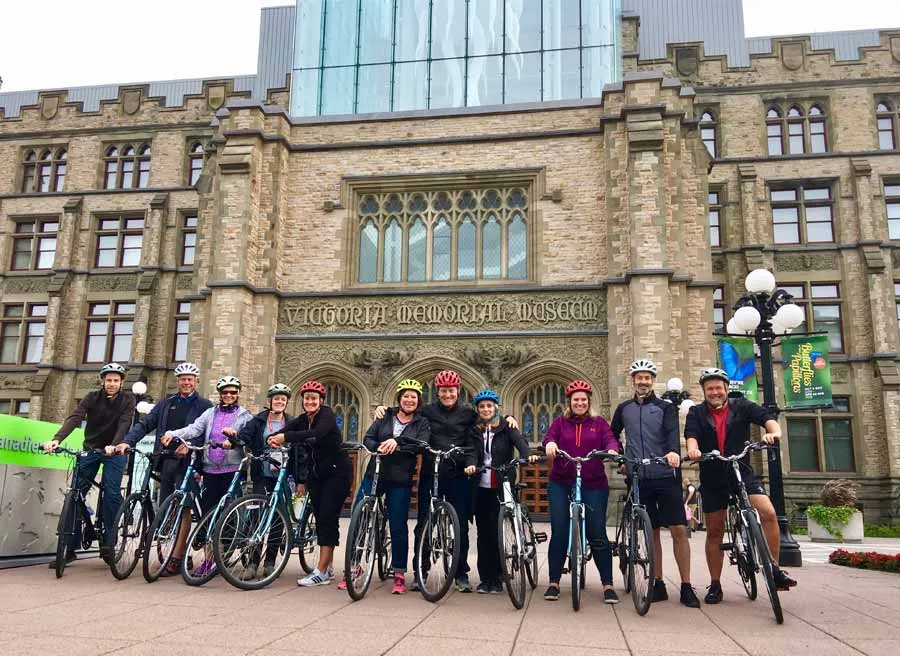group taking Escape Ottawa Bike Tour and stop at Canadian Museum of Nature to take a group picture