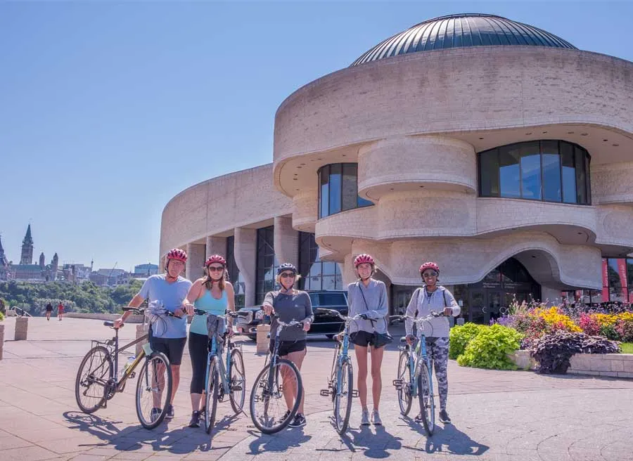 group taking Ottawa Bike Tour and stop at Canadian Museum of History to take a picture